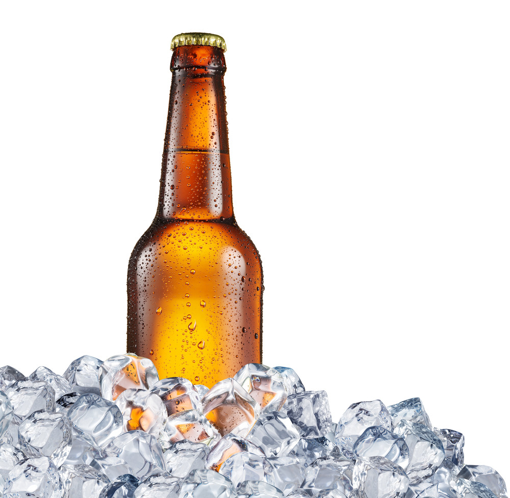 cold bottle of beer in the ice cubes. file contains clipping paths.