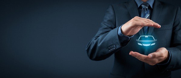 car (automobile) insurance and collision damage waiver concepts. businessman with protective gesture and icon of car. wide banner composition.
