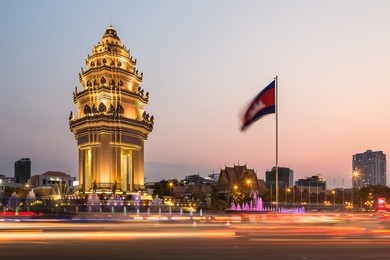 traffic rush around the independence monument, with its khmer architecture style, in phnom penh, cambodia capital city. blurred motion archived with long exposure.
