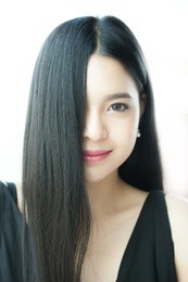 beautiful asian woman with straight healthy dark hair - haircare concept
