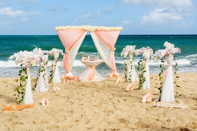set of accessories for a wedding on the shores of the caribbean sea. arch decorated with flowers