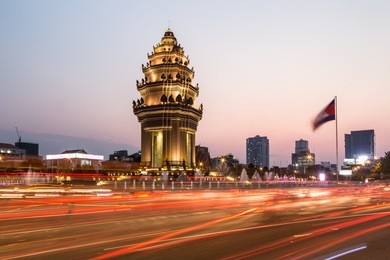 traffic rush around the independence monument, with its khmer architecture style, in phnom penh, cambodia capital city. blurred motion archived with long exposure.