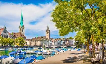 panoramic view of historic zurich city center with famous fraumunster and st. peter churches and river limmat at lake zurich on a sunny day with clouds in summer, canton of zurich, switzerland