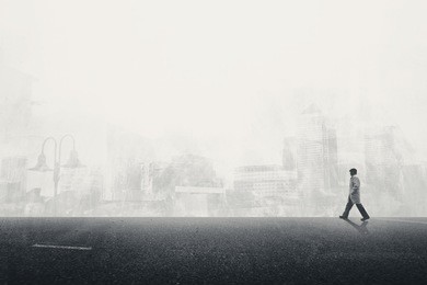 man walking on the grey street in city