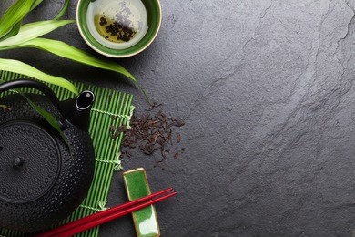 asian tea bowl and teapot over stone table. top view with copy space