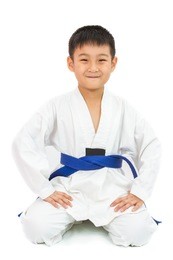 asian little karate boy in white kimono on white background