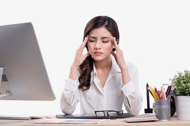 tired overworked freelancer working with a laptop in an office or home