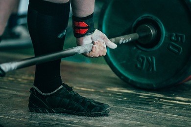 closeup of hands of powerlifter. deadlift barbell to competition