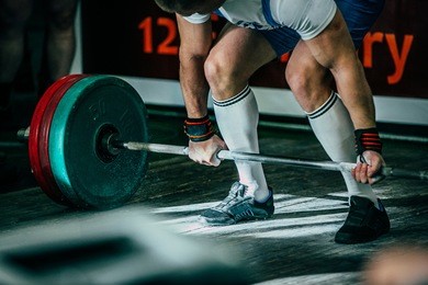 closeup athlete of powerlifter attempt deadlift a heavy barbell