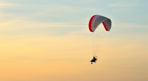 paraglider in flight  in summer at sunset