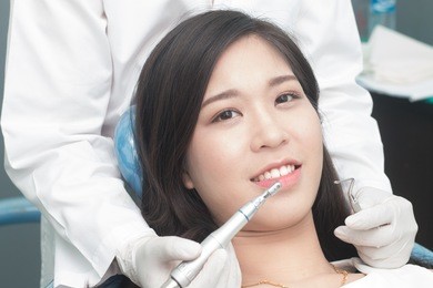 close up dentist curing a asian women patient, close up of asian women having his teeth examined by a dentist