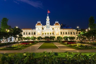 city hall building at night, ho chi minh city, vietnam.