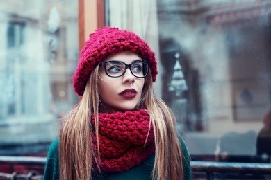 street portrait of beautiful young  fashionable woman with glasses looking aside.  lady wearing stylish winter clothes. model looking aside. female fashion. close up 