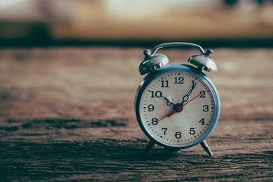 vintage alarm clock on weathered wood background