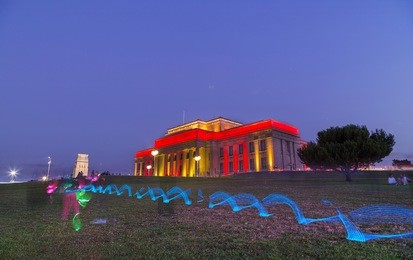 the auckland museum lit in red and yellow colors complementing the chinese lantern festival at the domain 