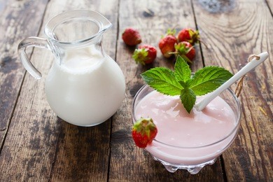 strawberry yogurt and milk on a table, selective focus