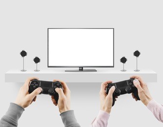 man hold gamepad in hands in front of blank tv screen mock up playing game. clear monitor mockup with gamer first person. men play video games on console station. people gaming contest. two players.