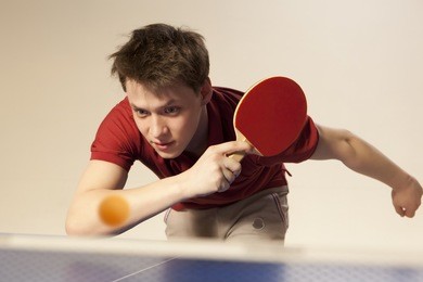 young man playing ping pong