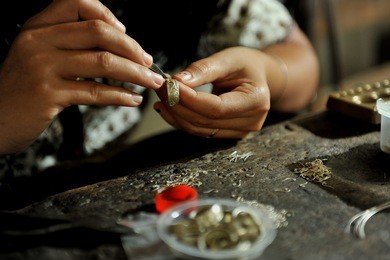 balinese women working on a silverware at celuk village, bali, inodnesia