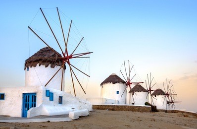 scenic view of traditional greek windmills on mykonos island at sunrise, cyclades, greece