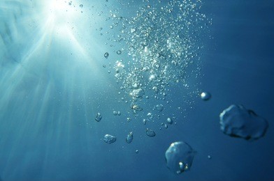 underwater bubbles with sunlight through water surface, natural scene, caribbean sea