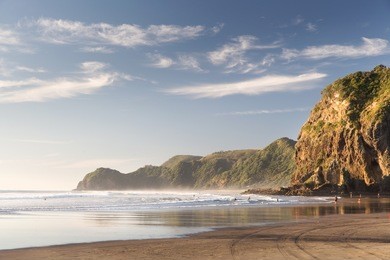 piha beach at sunset, auckland, new zealand