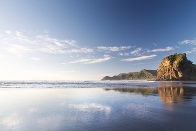 piha beach at sunset, auckland, new zealand