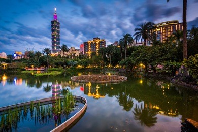 taipei 101 and a lake at zhongshan park at night, in xinyi, taipei, taiwan