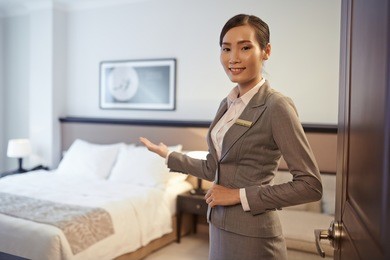 vietnamese hotel customer service representative showing double room