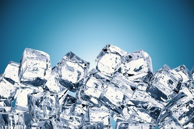 heap of ice cubes on blue background