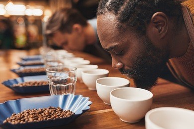 coffee tasting with baristas smelling the aroma of many cups