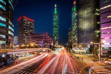 traffic on xinyi road and view of taipei at night, in taipei, taiwan.