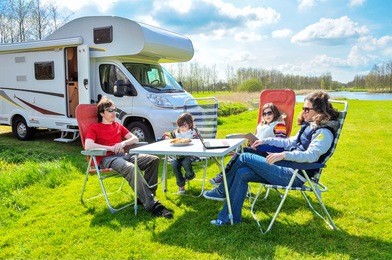 family vacation, rv (camper) travel with kids, happy parents with children on holiday trip in motorhome
