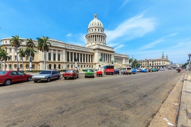 the capitol building and heavy traffic of city center,  havana, cuba