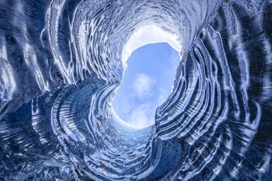 looking up through a opening in a glacier cave in iceland 