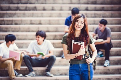 group of happy teen high school students outdoors