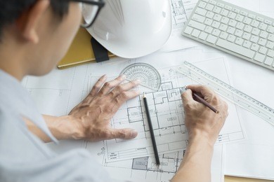 architect or engineer working on blueprint, construction concept. engineering tools.vintage tone retro filter effect,soft focus(selective focus)