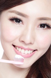 close up of smile woman brush teeth. great for health dental care concept, isolated over white background. asian