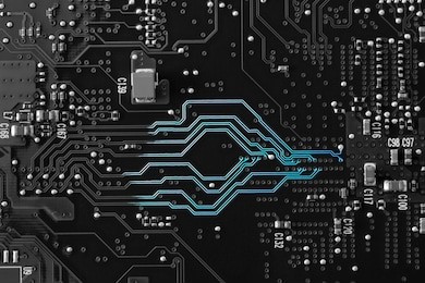 a black and white circuit board with neon blue showing on the lines to show the communication highway of the circuitry. flat layout, copy space, use as a horizontal or vertical format.