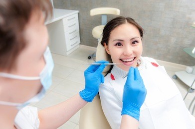 young female patient at dentist office