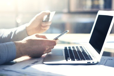 photo businessman working with generic design notebook smartphone. online payments credit card, texting keyboard. blurred background, film effect. horizontal