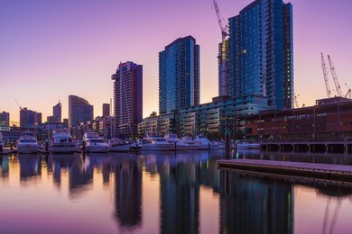 docklands, melbourne high rise residential buildings and moored yachts at dawn