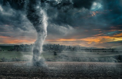 black tornado funnel over field during thunderstorm