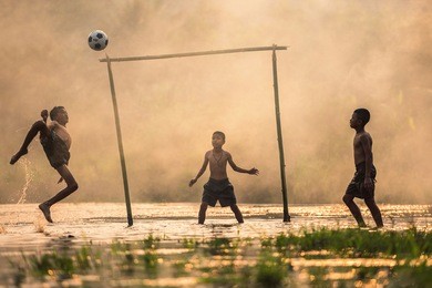 boy kicking a soccer ball 