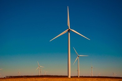 wind energy blows into future amarillo and west texas wind turbine farms in the lone star state at colorful sunset with all colors of the rainbow showing renewable energy works