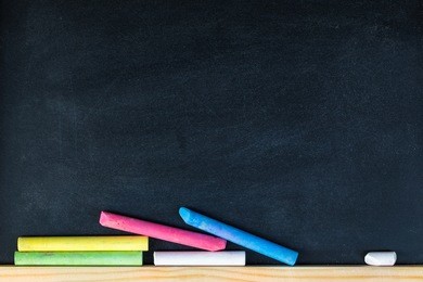 chalk rubbed out on blackboard for background. empty blank black chalkboard with chalk traces