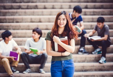 group of happy teen high school students outdoors
