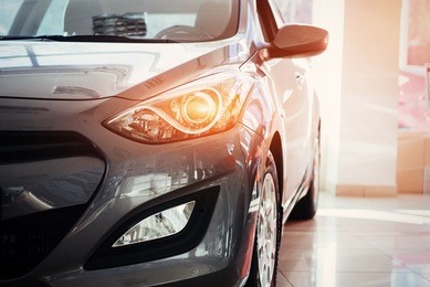 the headlights and the hood of a black sports car.