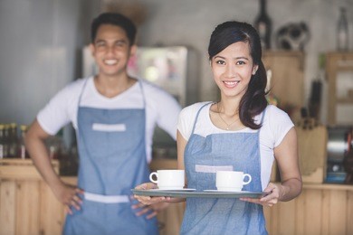 waitress holding tray with cappuccinos at the coffee shop