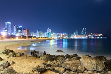 busan, korea - january 21, 2016: night view of haeundae beach. haeundae beach is busan's most popular beach because of its easy access from downtown of busan and the beautiful beach.